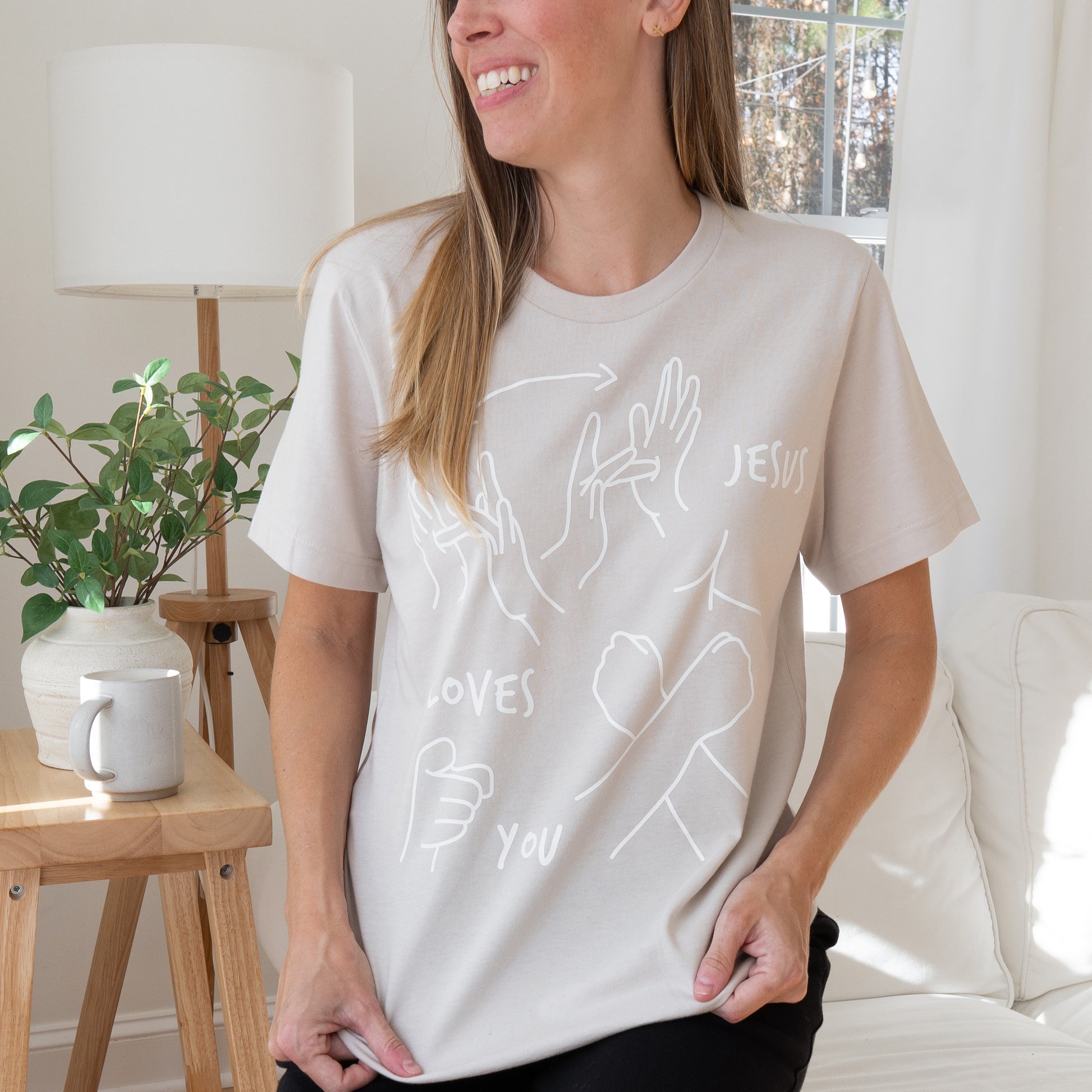 Oatmeal ASL T-shirt with front design of Jesus Loves You in sign language.
