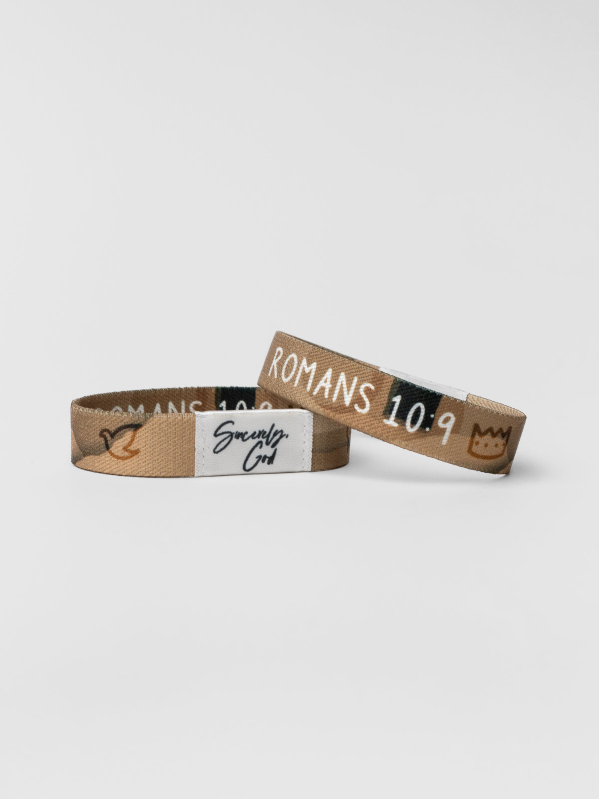 Two wristbands with text on a light gray background