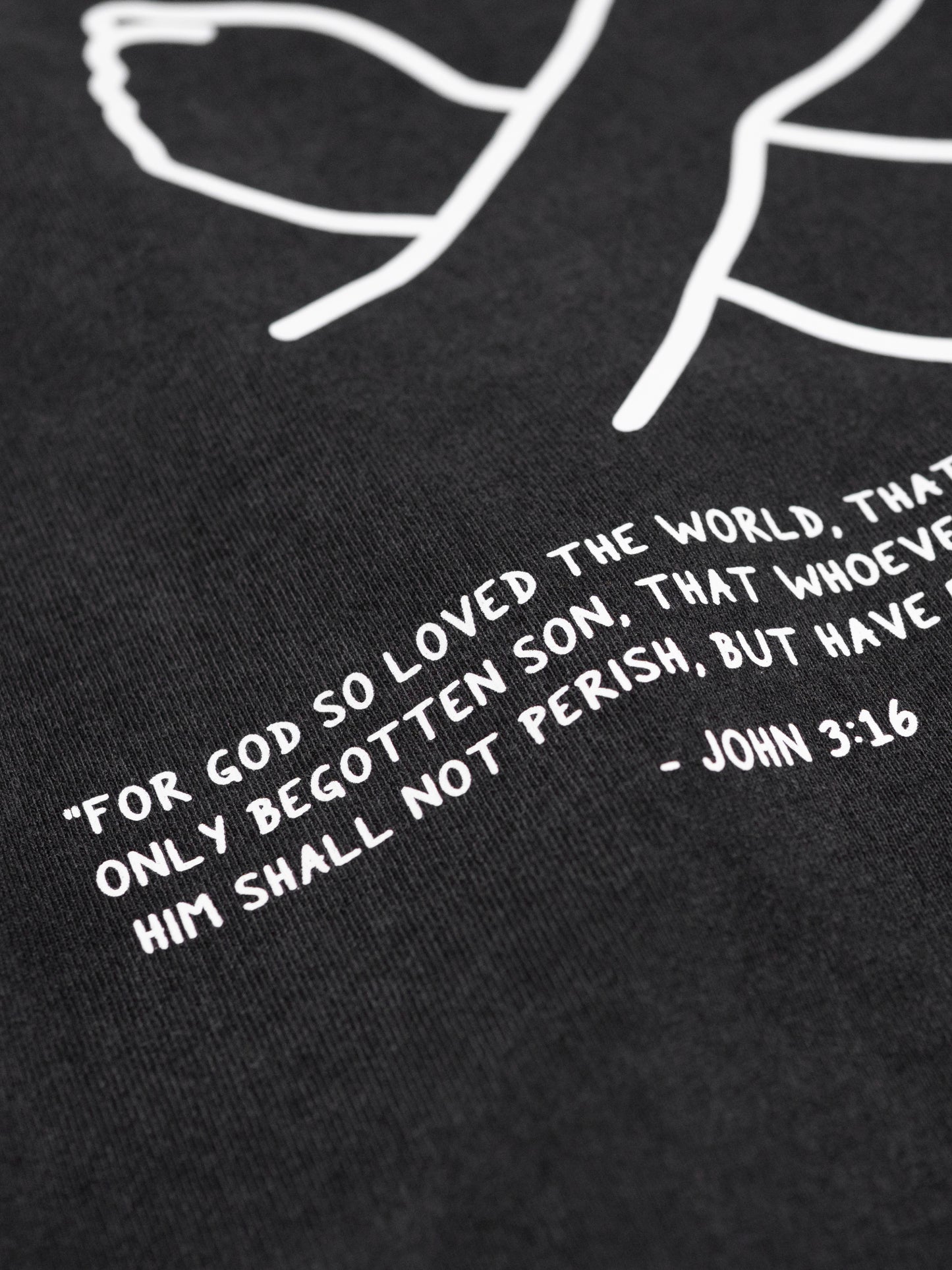 Black t-shirt with white text and minimalistic design on a black background