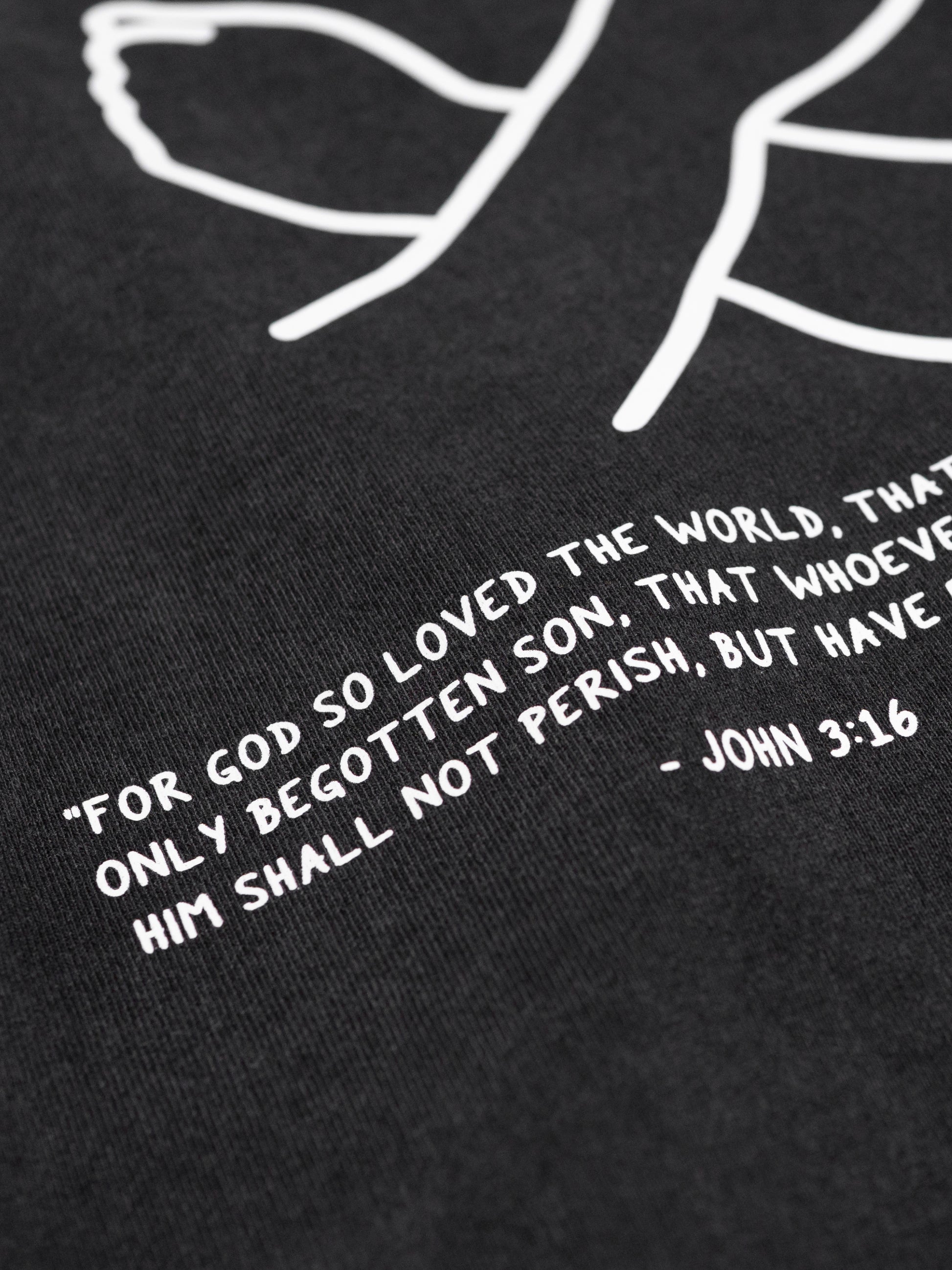 Black t-shirt with white text and minimalistic design on a black background