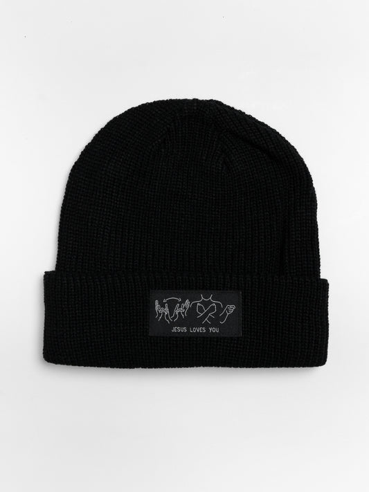 Black beanie with a patch on a white background