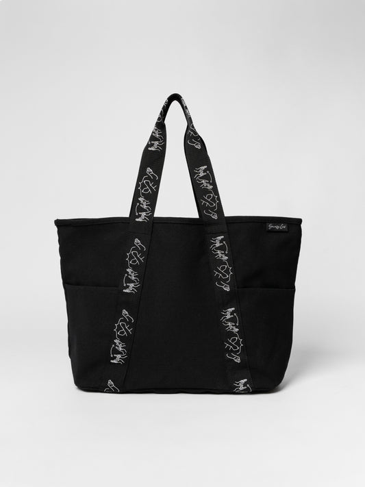 Black tote bag with floral straps on a white background