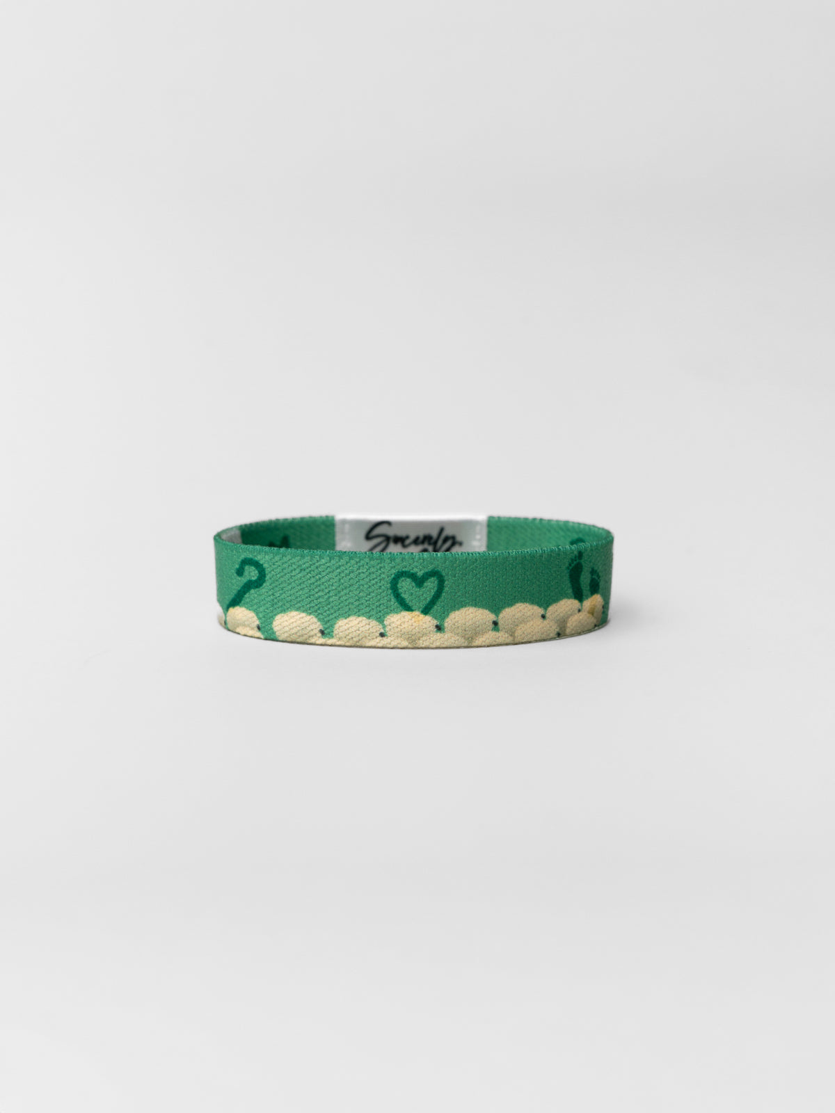 Green bracelet with heart design on a white background