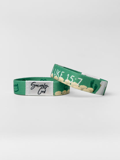 Green wristband with text on a white background