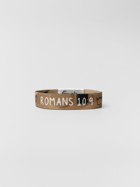 Brown wristband with 'Romans 10:9' text on a white background