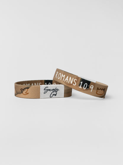 Two wristbands with text on a light gray background
