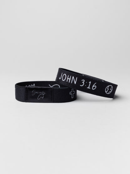 Two black wristbands with text on a light gray background