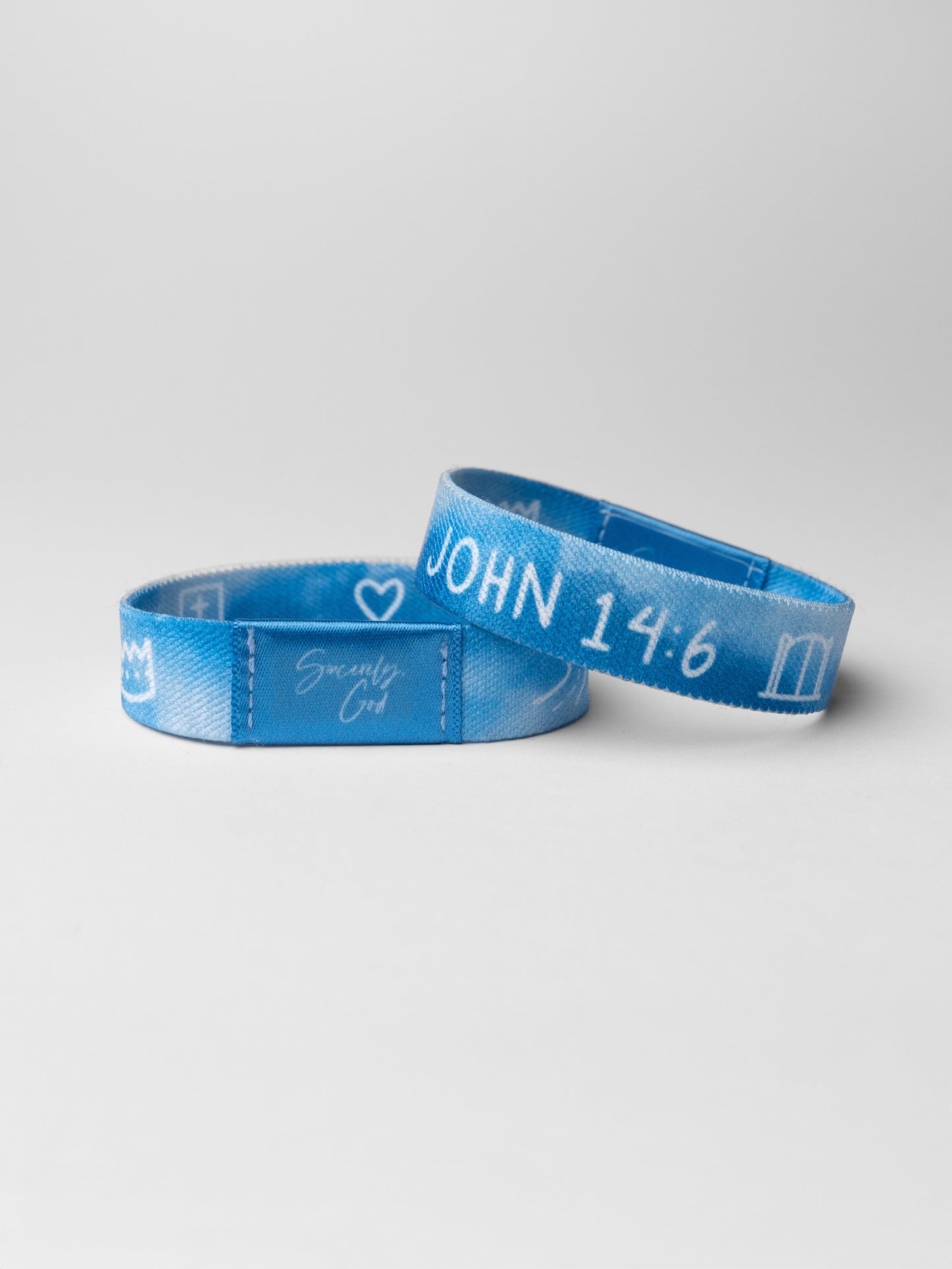 Two blue wristbands with text on a light gray background
