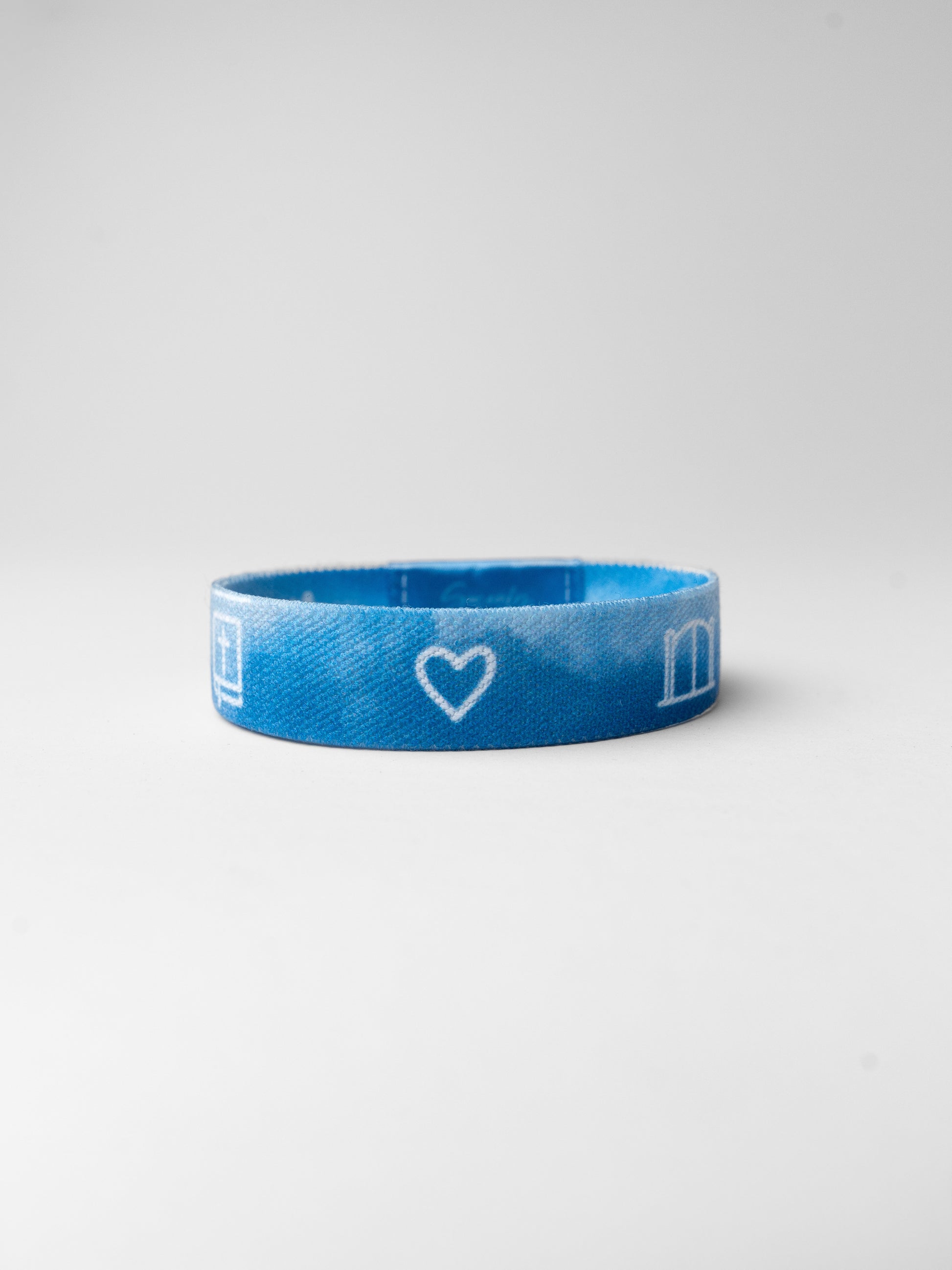 Blue wristband with a heart and letter 'm' on a white background