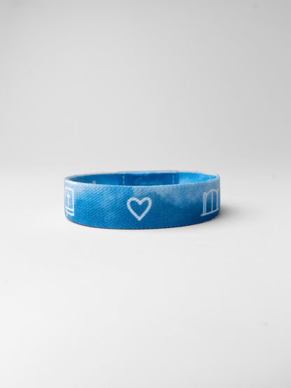 Blue wristband with a heart and letter 'm' on a white background