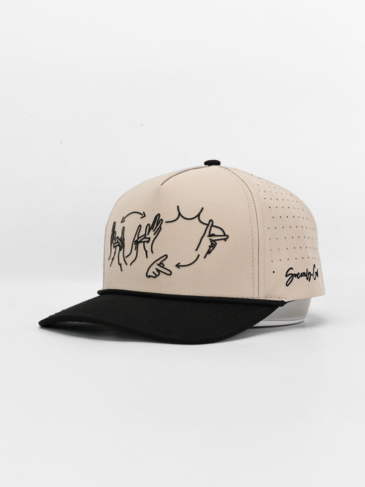 Beige and black cap with graphic design on a white background